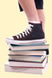 Teen foot on books
